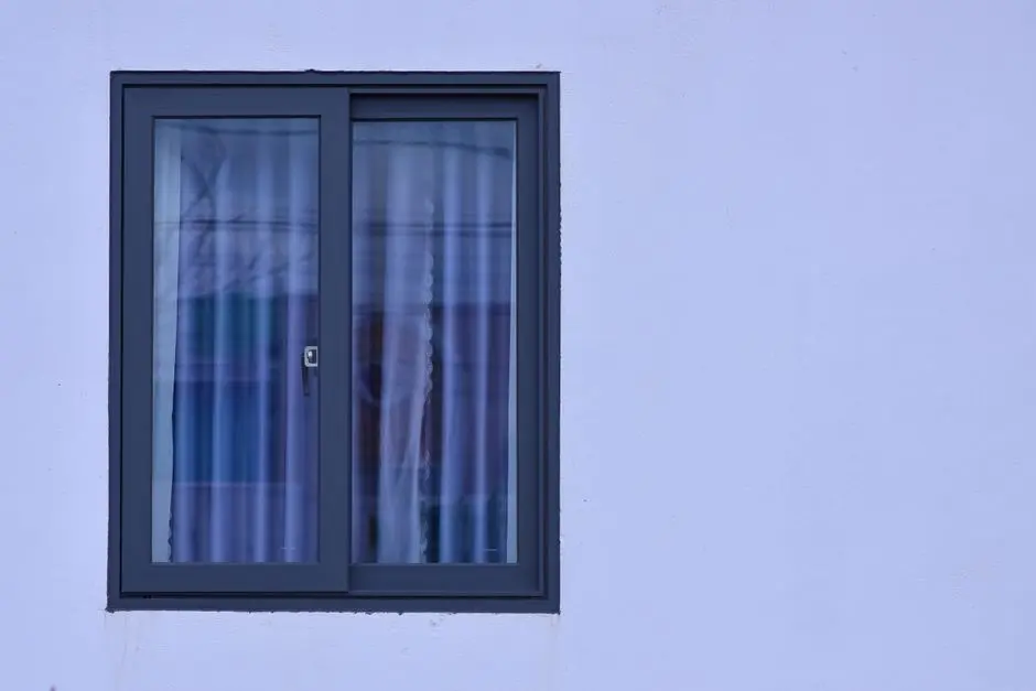 A minimalist view of a modern window with frosted glass on a light blue wall.